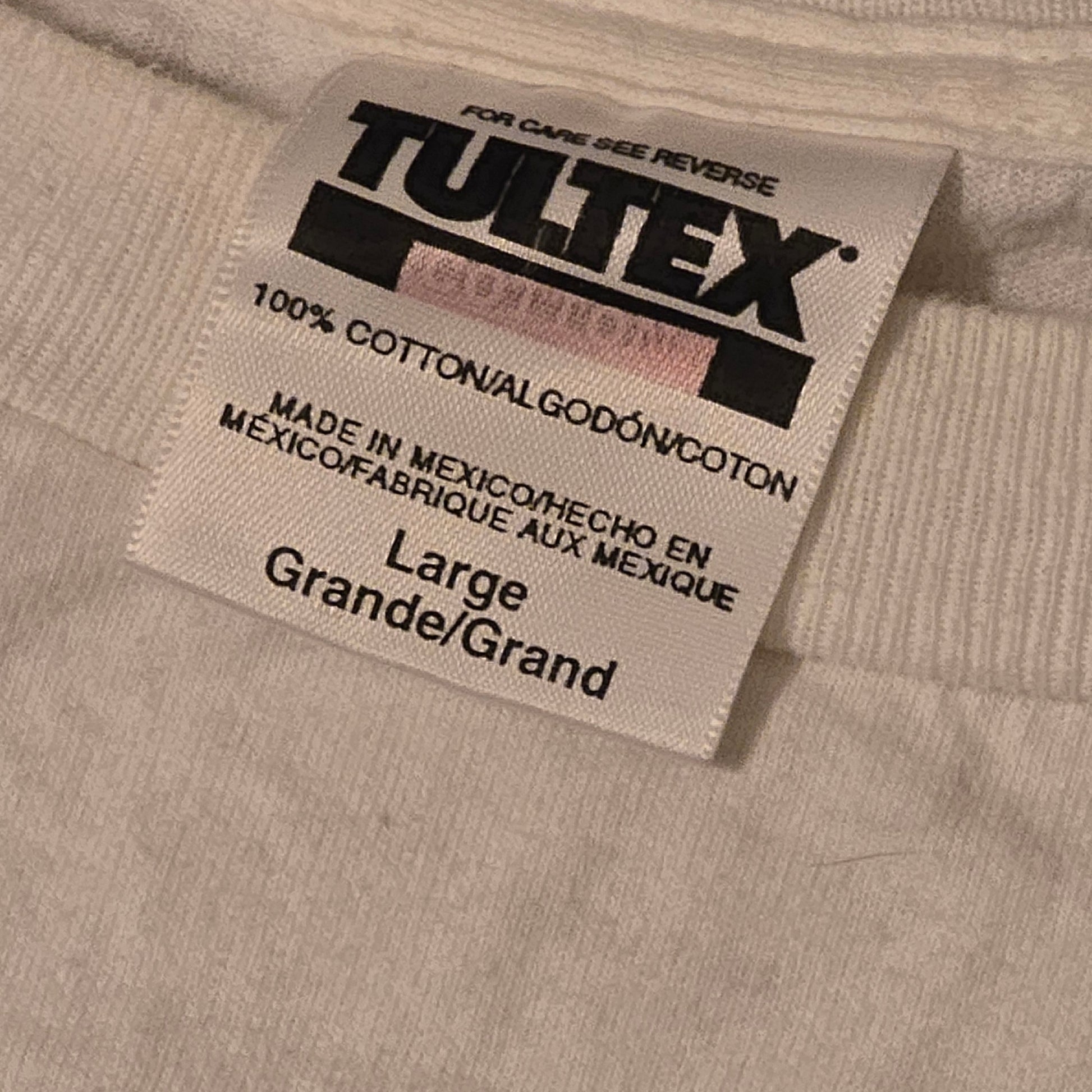 Close-up of Tultex clothing tag on vintage 1994 Megadeth T-shirt, 100% cotton, made in Mexico, size large