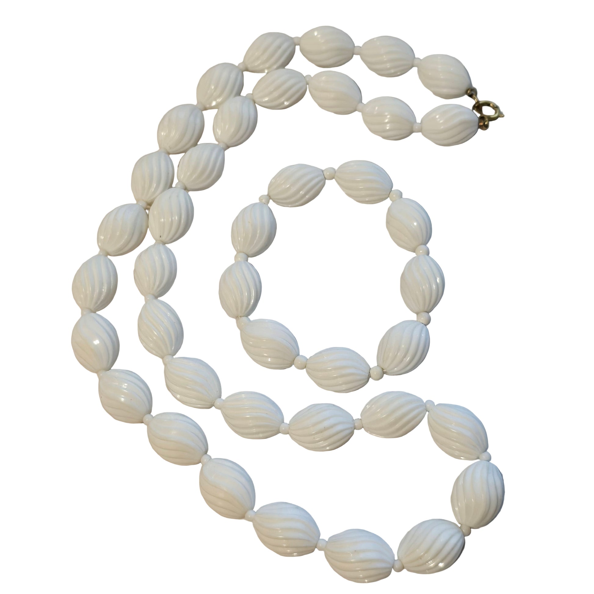 White beaded necklace on a light gray background