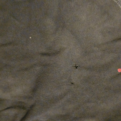 Close-up of dark fabric with small holes and imperfections
