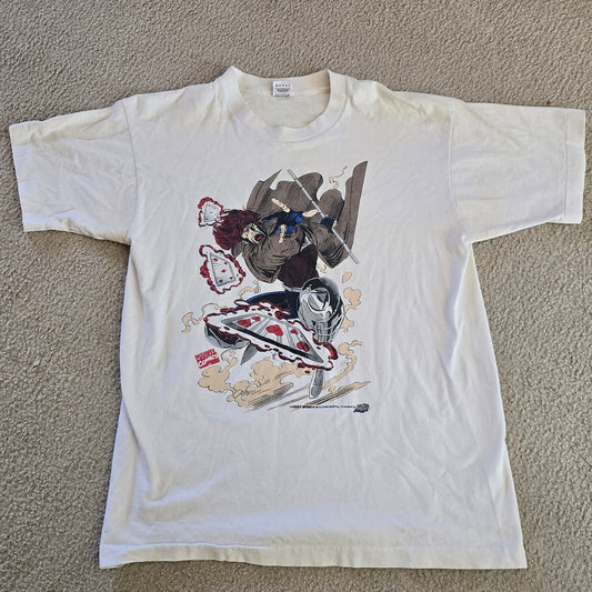 White t-shirt with colorful graphic design on a beige carpet