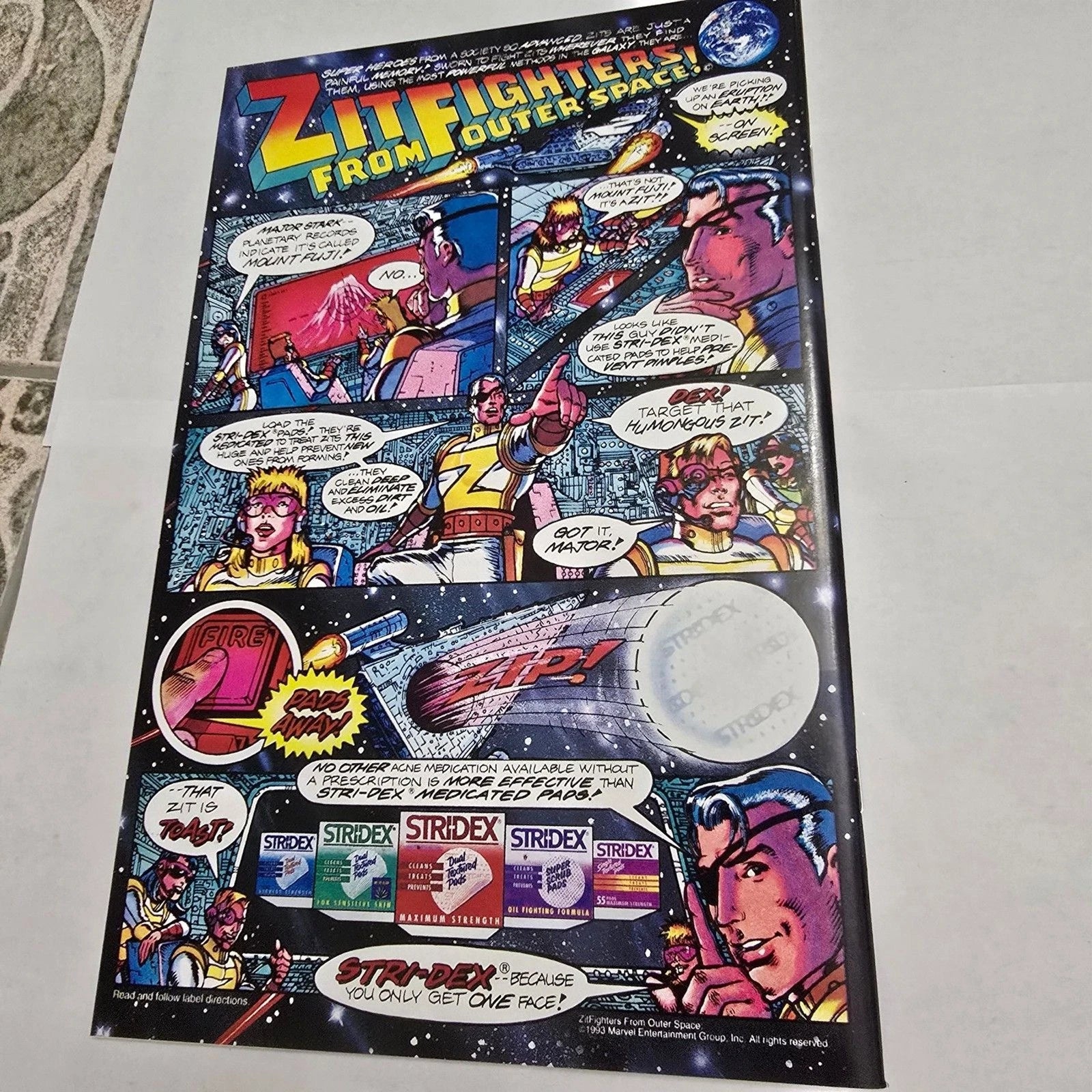 Comic-style advertisement for Striderex with space-themed graphics on a flat surface.