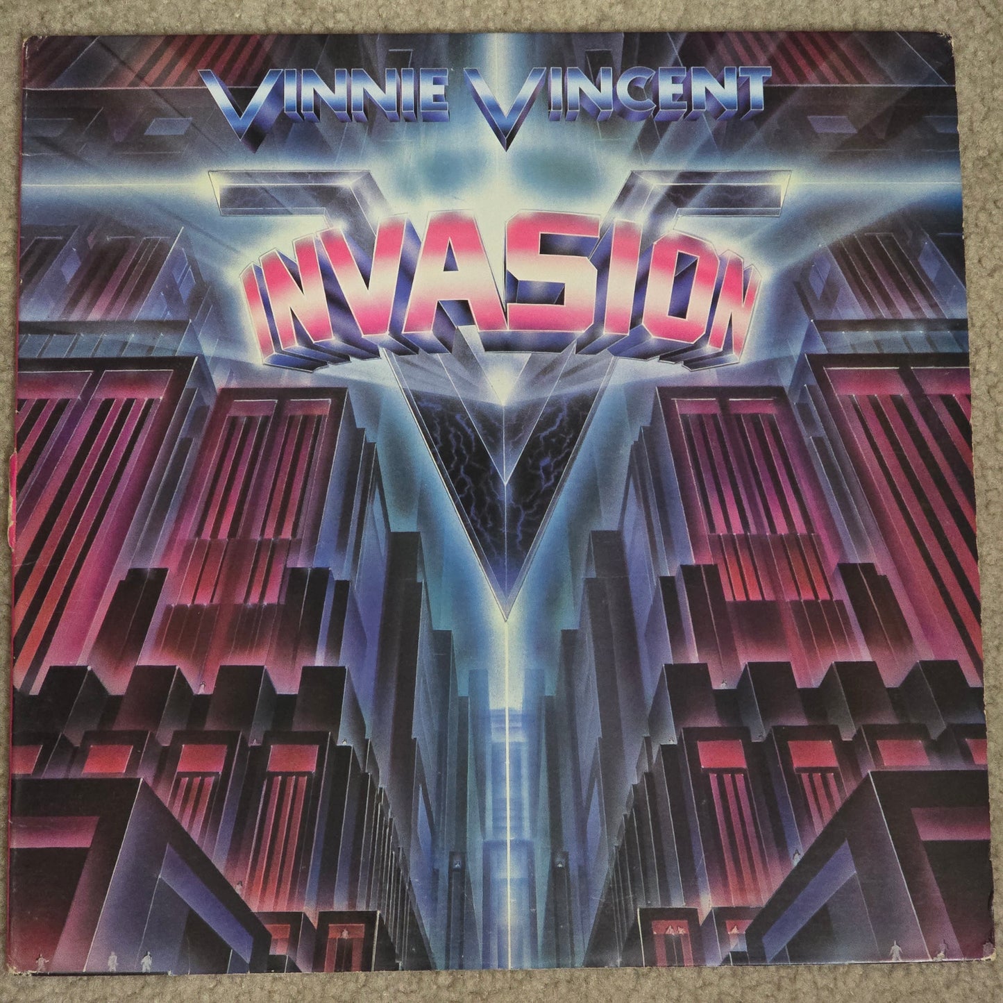 Vinnie Vincent Invasion self-titled LP front cover with pink logo on dark background.