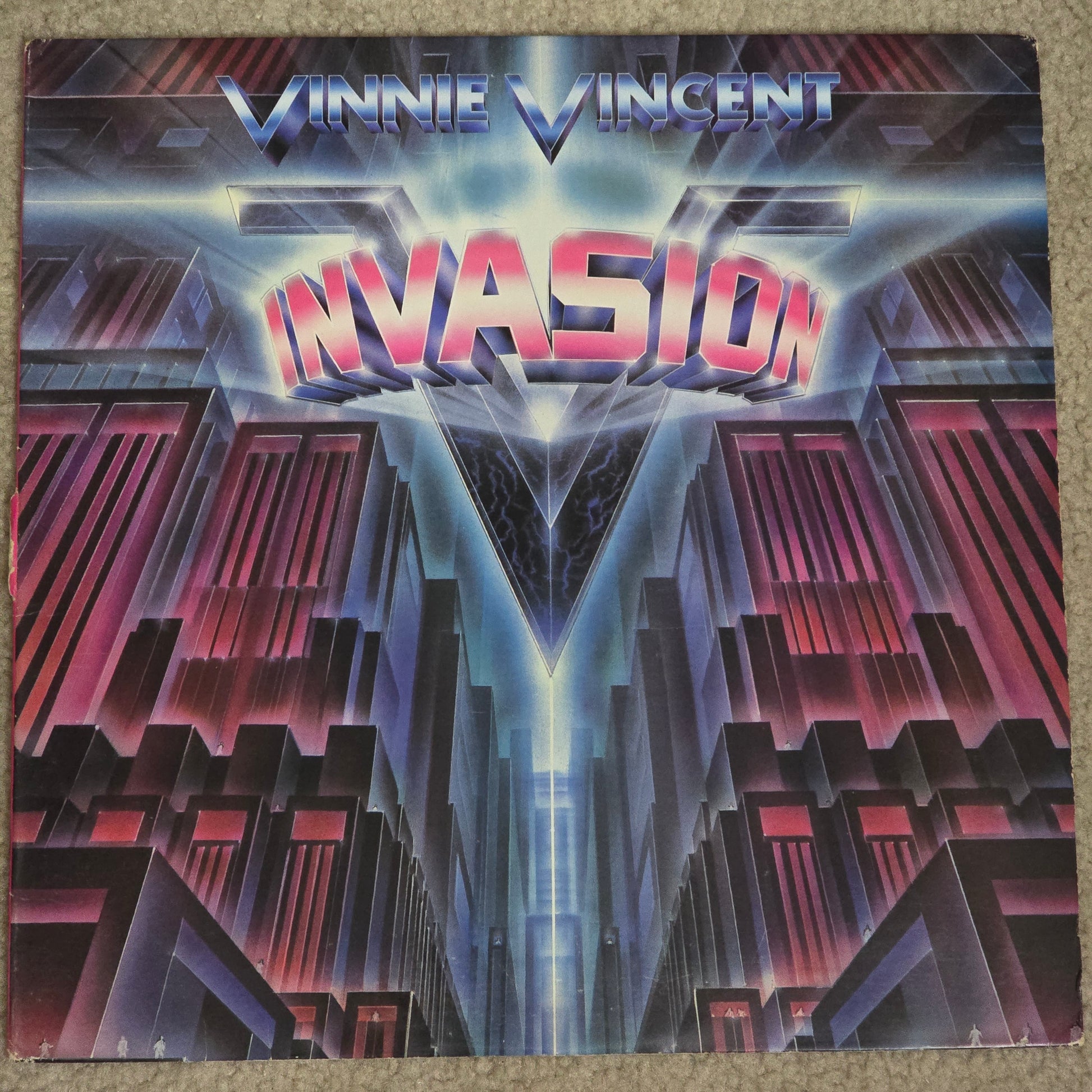 Vinnie Vincent Invasion self-titled LP front cover with pink logo on dark background.