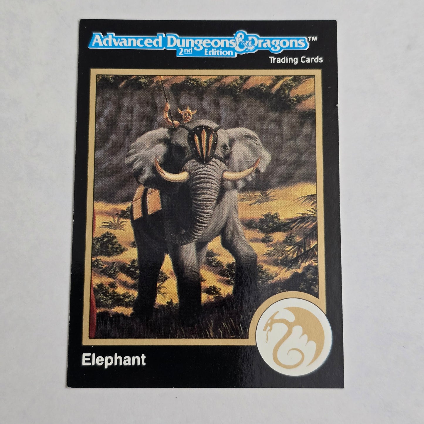 Trading card featuring an elephant with a decorative headdress on a gray background