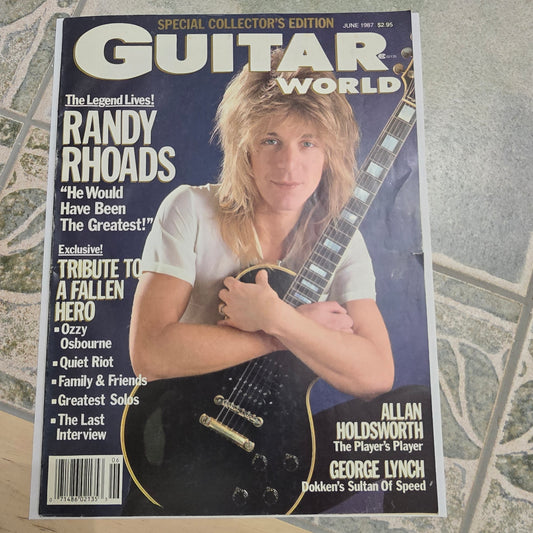 Magazine cover featuring a woman holding a guitar with text about Randy Rhoads on a textured surface.