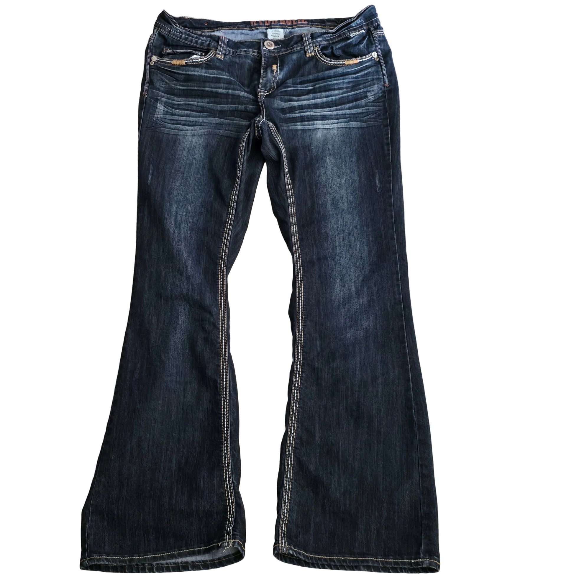 Pair of dark blue jeans laid flat on a beige surface