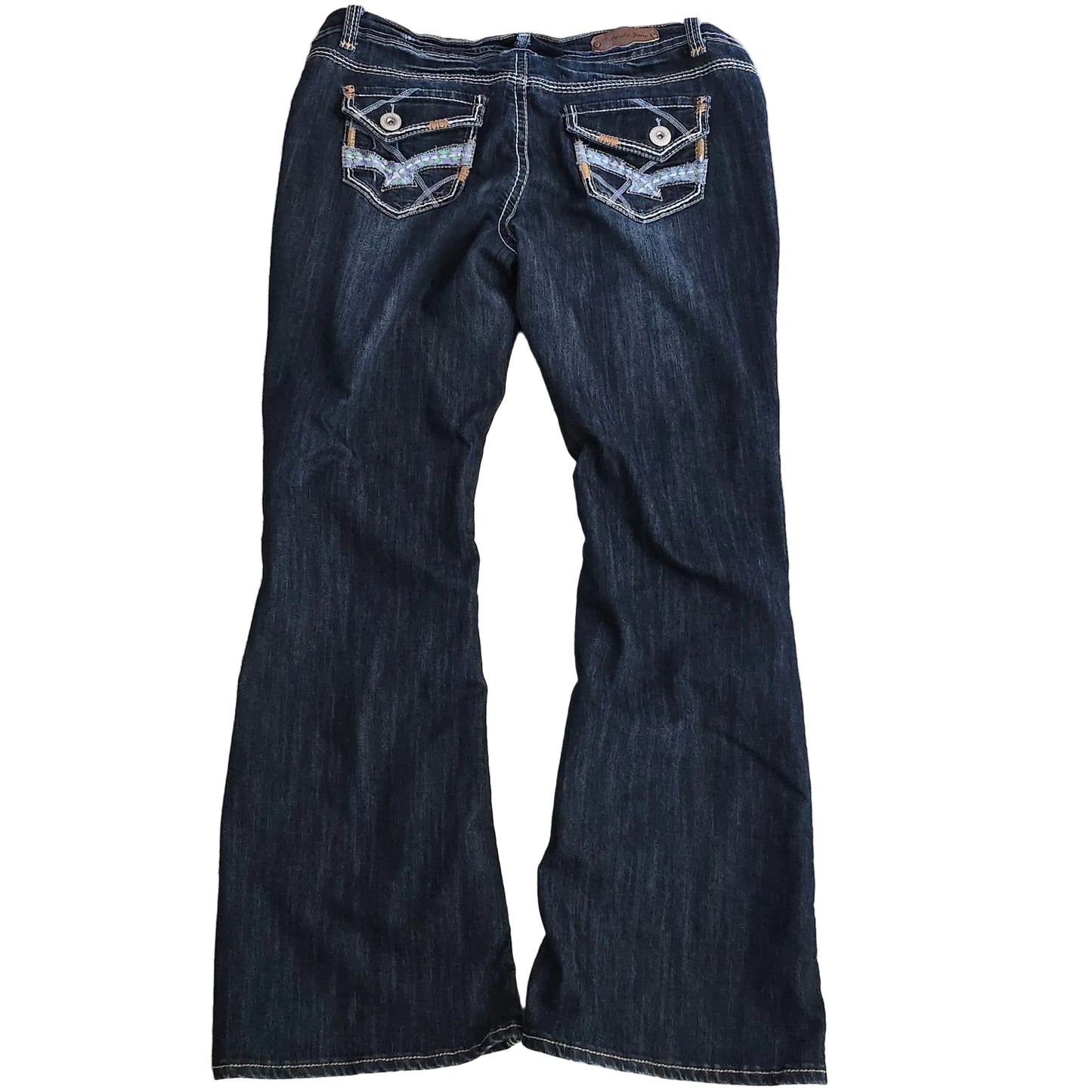 Folded pair of dark blue jeans on a beige carpet
