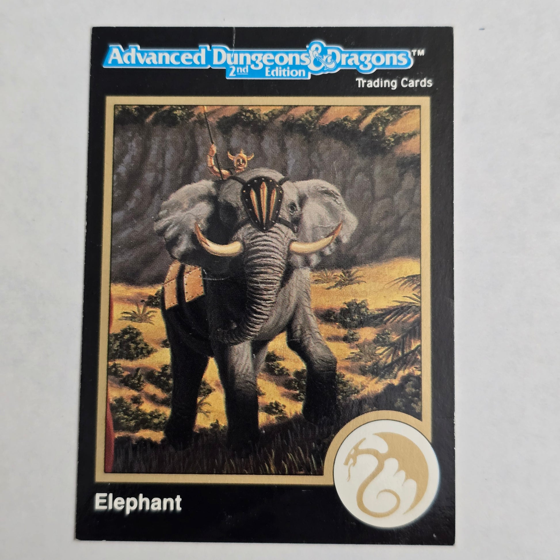 Trading card featuring an elephant with a fantasy design on a plain background
