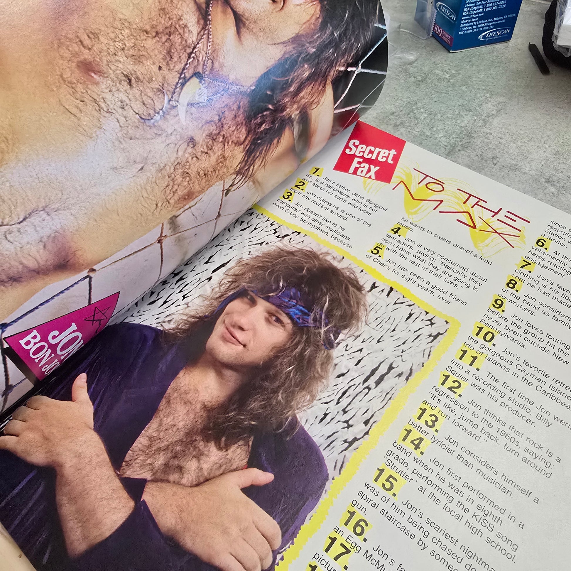 Magazine with a cover featuring a person with long hair and a bandana, held by another person.